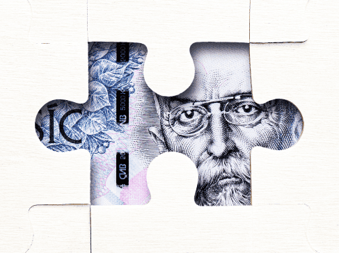 Dílek puzzle, ve kterém je vidět část bankovky